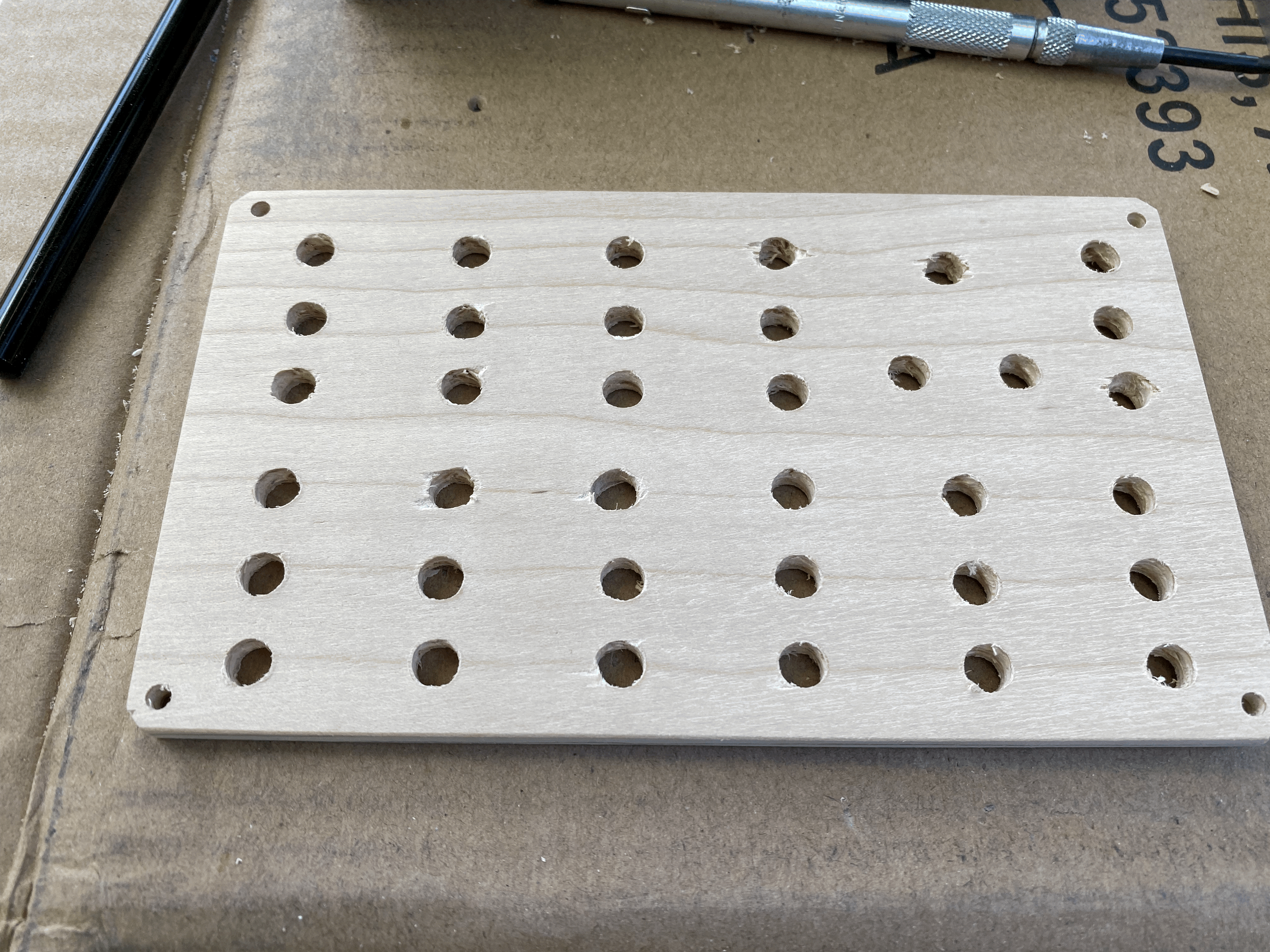 Wooden synthesizer front panel with cleanly-drilled holes for components